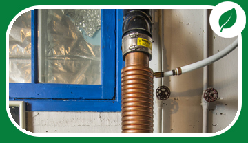 Copper tubing wrapped around a drain pipe