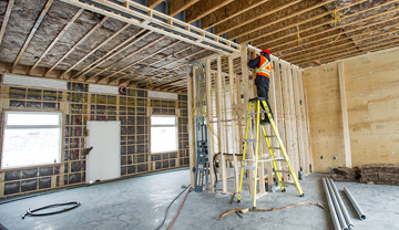 Construction worker working inside a new house