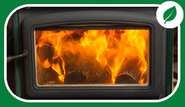 Front of wood stove with flames showing through glass