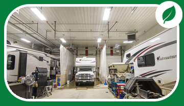 Inside shop showing recreational vehicles under bright lights