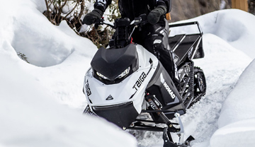 Snowmobile on a forested trail