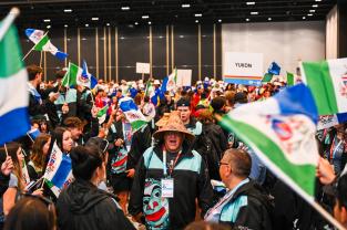 Gordon Reed, the President of the Yukon Aboriginal Sports Circle, chanting with Team Yukon before the opening Ceremonies in Halifax.